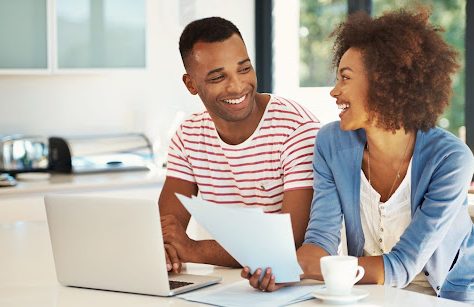 Couple smiling looking at computer